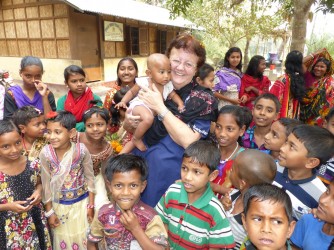 Donor with Children in a  Village 