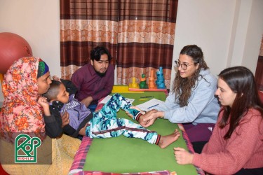 Two Italian physiotherapists providing dedicated care during the 'Free Physiotherapy Camp' organized by Rishilpi, supporting the well-being of the local community.