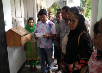 Members of the Complaint and Response Committee of the Dhulihar Union Parishad are opening the complaint box.