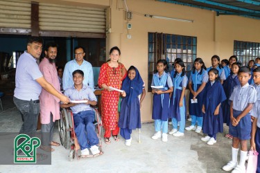 Distributing educational materials among the sponsored students.